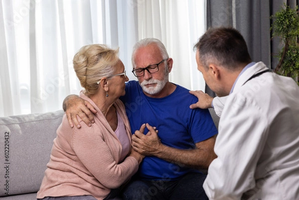 Fototapeta Distressed worried senior couple hugging after bad medical result while doctor is comforting them