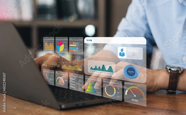 Obraz Business strategy concept for the development of the organization. Businessman use laptops to work on virtual smart digital screens, Analyze statistical Marketing data,Data management