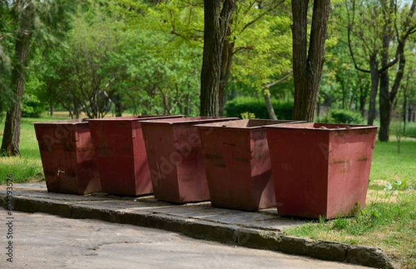 Fototapeta Empty metal trash cans in the park