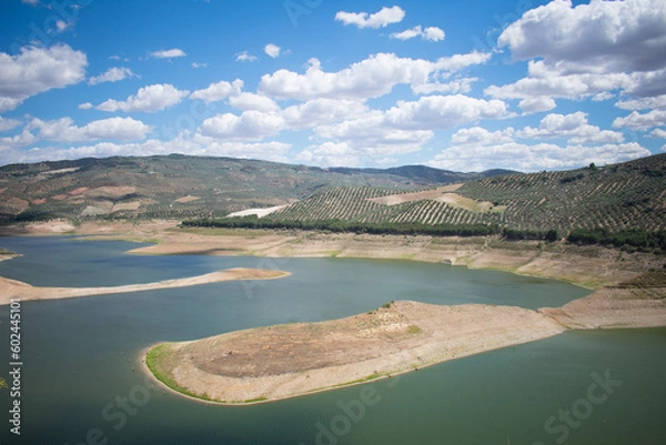 Fototapeta Landscape with a very large and green lake. Landscape with mountains full of olive trees and a clear sky. Typical landscape of the Spanish coasts. Typical Spanish landscape.