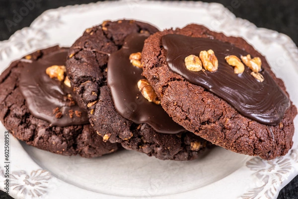 Fototapeta A 'Chocolate Afghan' cookie covered with chocolate topping and pieces of peanut.