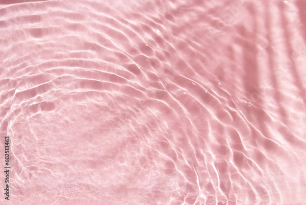 Fototapeta Summer creative layout with palm tree leaf shadow and pastel pink water ripple background. 80s or 90s retro aesthetic fashion idea. Minimal tropical summer idea.