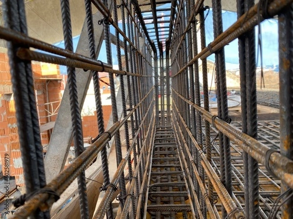 Obraz binding of reinforcement of a bearing beam monolithic reinforced concrete slab of a residential building before pouring concrete
