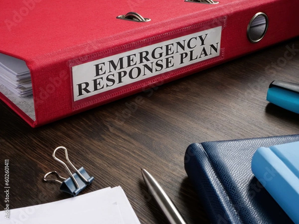 Obraz Red folder with Emergency response plan on the desk.