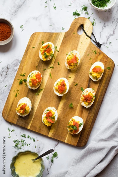 Obraz Homemade deviled eggs with salmon on a black background.