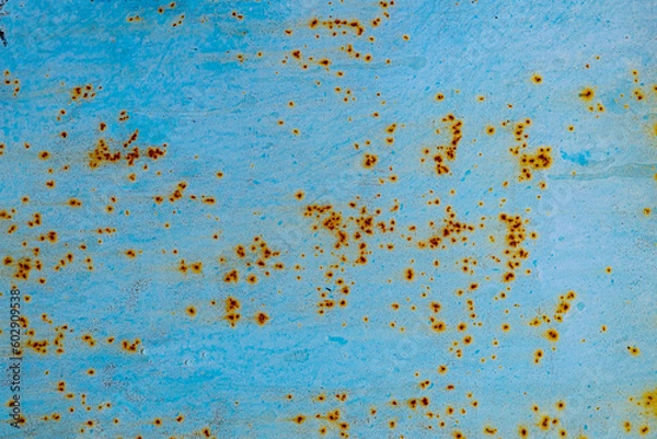 Fototapeta The texture of cracked blue paint on an iron sheet.