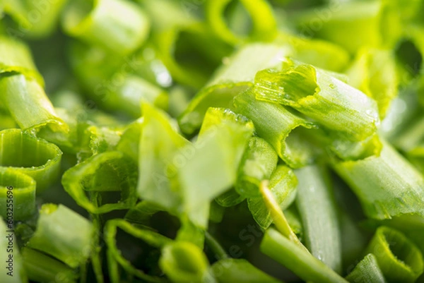 Fototapeta chopped green onions. Eds background is a green onion. Green Perya onion cut for freezing. Background from the cut bow