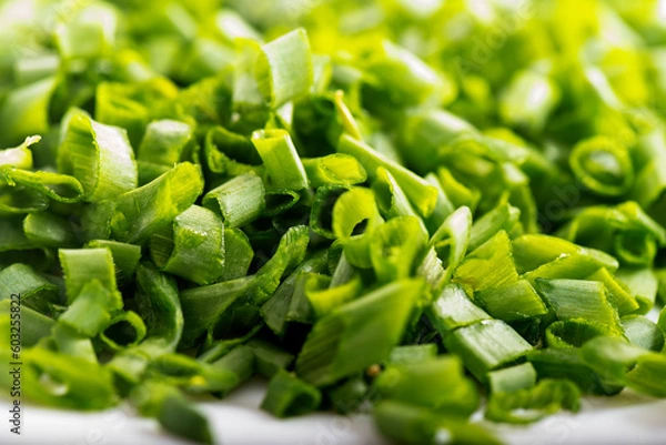 Fototapeta chopped green onions. Eds background is a green onion. Green Perya onion cut for freezing. Background from the cut bow