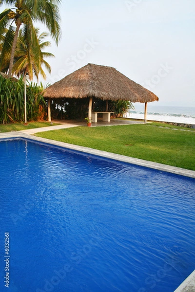 Obraz Luxury tropical pool overlooking ocean and cabana