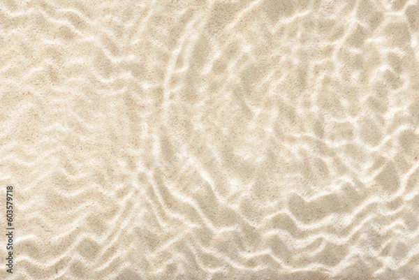 Fototapeta sun lights shadow in wavy water on abstract sand background, beautiful abstract spa concept banner of sea paradise island