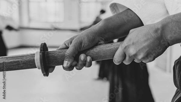 Obraz People practicing aikido martial art in a dojo background.