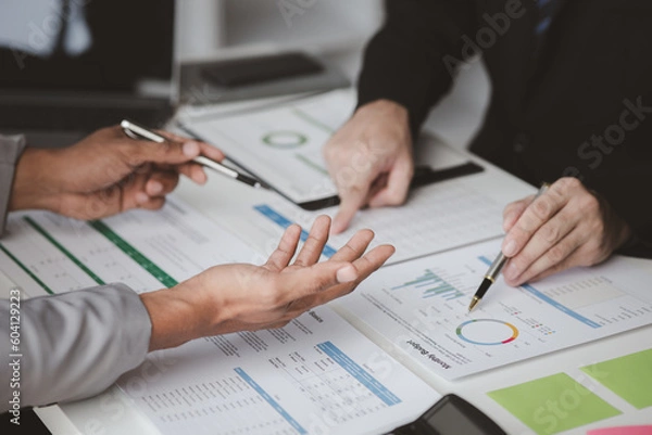 Fototapeta Executives and managers are meeting in a conference room, on the table there are some documents about the company's finances, managers are discussing financial information with the management.