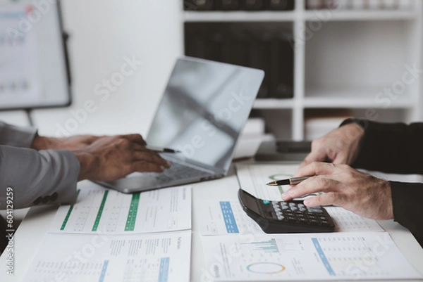 Fototapeta Executives and managers are meeting in a conference room, on the table there are some documents about the company's finances, managers are discussing financial information with the management.