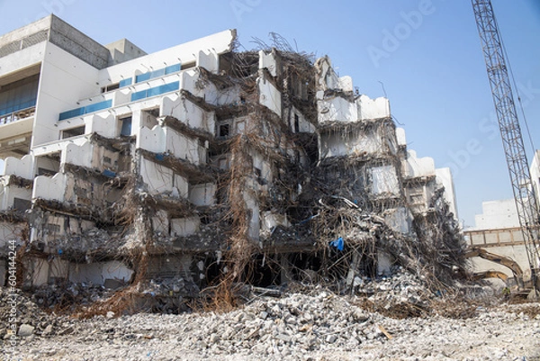 Fototapeta Demolition of old building with debris and steel reinforcement. earthquake and natural disasters 