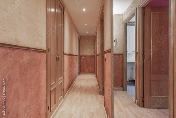 Fototapeta An empty apartment with two-color walls and a border with access doors