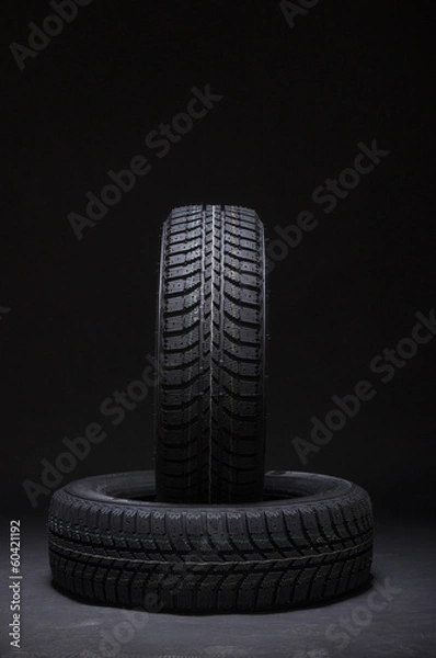 Obraz Vertical and horizontal winter tyres on black background