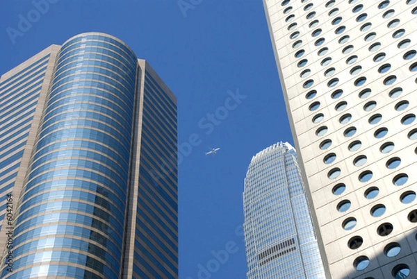 Obraz a plane flys past hong kong sky scrapers