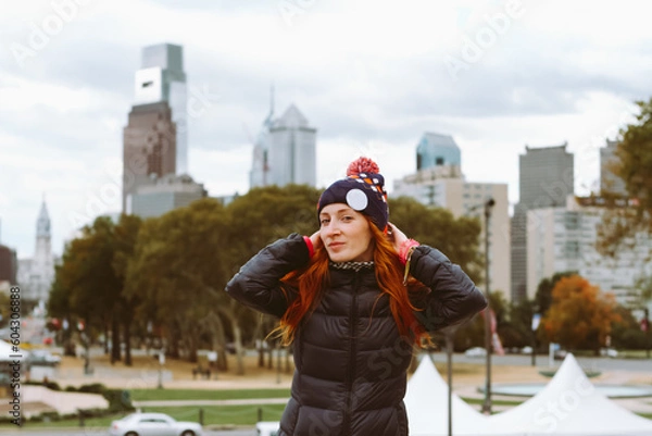 Obraz young red-haired woman on the background of downtown