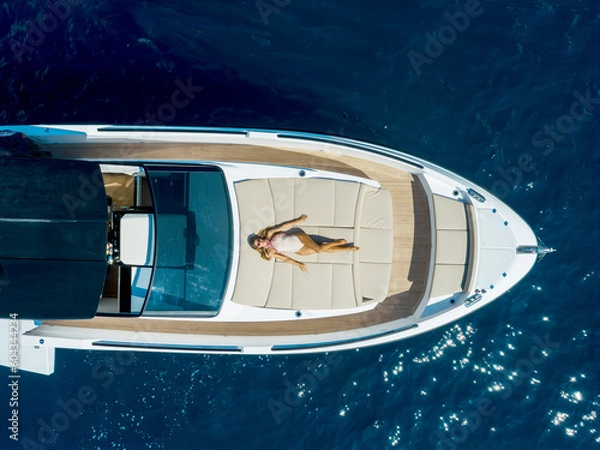 Fototapeta aerial view Young woman on a yacht in the amalfi coast, positano, italy