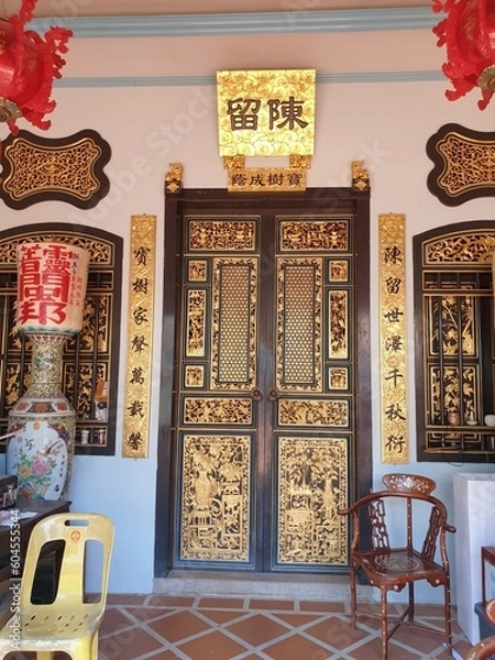 Fototapeta Photo of a door in a Chinese temple, in golden tones.