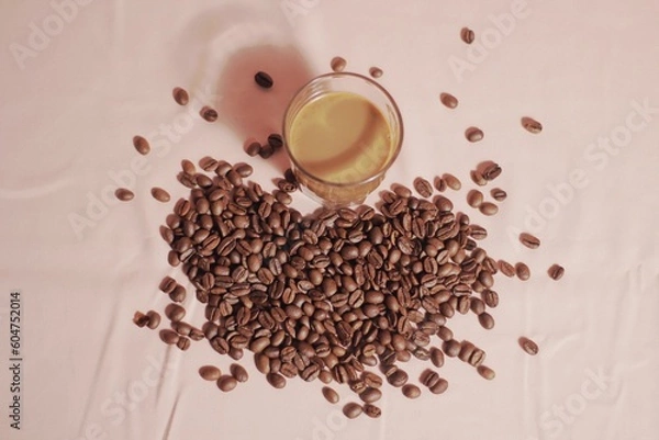 Obraz Cup of coffee with and coffee beans on peach color background. Creative layout. Breakfast concept. Top view, flat lay