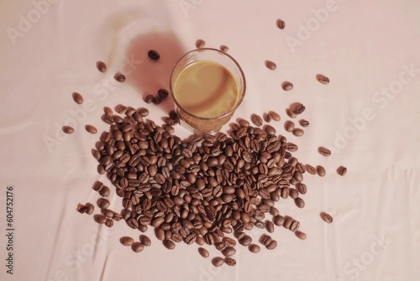 Obraz Cup of coffee with and coffee beans on peach color background. Creative layout. Breakfast concept. Top view, flat lay