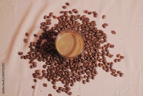 Obraz Cup of coffee with and coffee beans on peach color background. Creative layout. Breakfast concept. Top view, flat lay