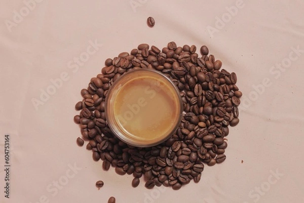 Obraz Cup of coffee with and coffee beans on peach color background. Creative layout. Breakfast concept. Top view, flat lay