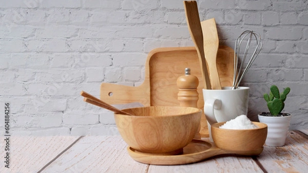 Fototapeta Kitchen accessories in white wooden table and white background and white tableware with salt in wooden bowl and tree. Kitchen minimal cooking time in holiday concept.
