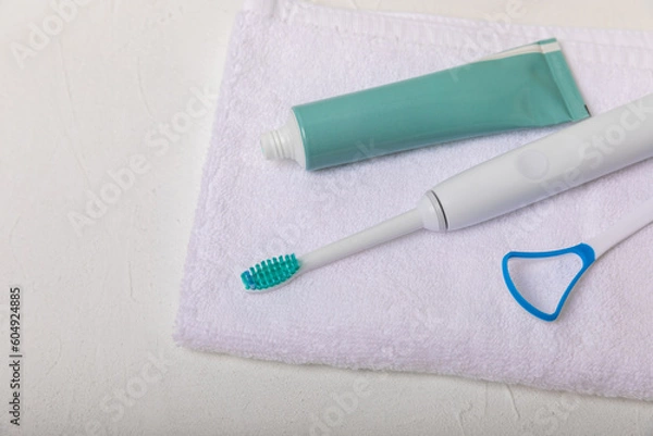 Fototapeta Toothbrush and tube of toothpaste on marble background with copy space. Flat lay. Oral hygiene. Oral Care Kit. Dentist concept. Place for text. Place to copy.