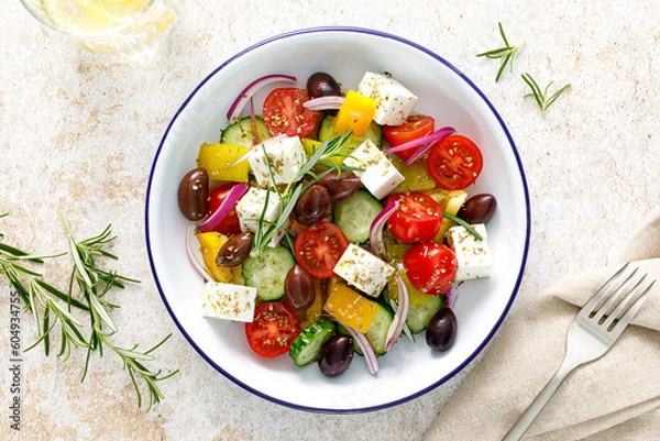 Obraz Greek salad. Vegetable salad with feta cheese, tomato, olives, cucumber, red onion and olive oil. Healthy vegetarian mediterranean diet food. Top view