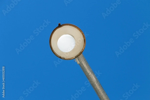 Fototapeta Public light seen from below with sky background.