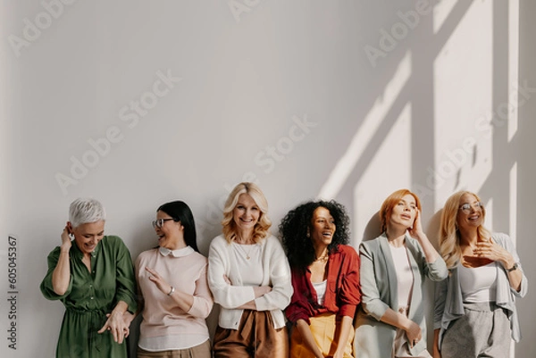 Obraz Multi-ethnic group of relaxed mature women bonding and smiling while leaning on the wall
