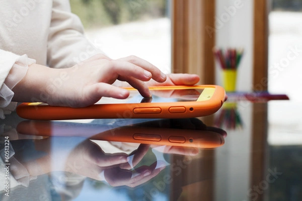 Fototapeta child uses a Tablet PC