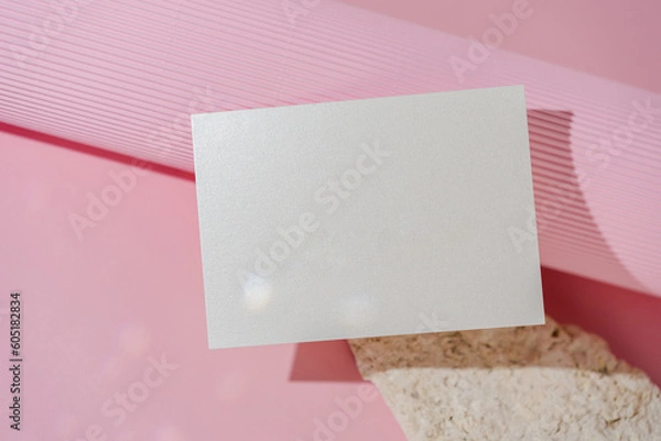 Fototapeta White glitter wedding invitation card mockup on pink background top view. Folded woman business card mock up. Name card, place card, birthday folded card mockup