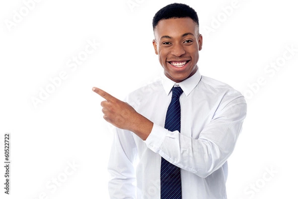 Obraz Smiling businessman pointing away