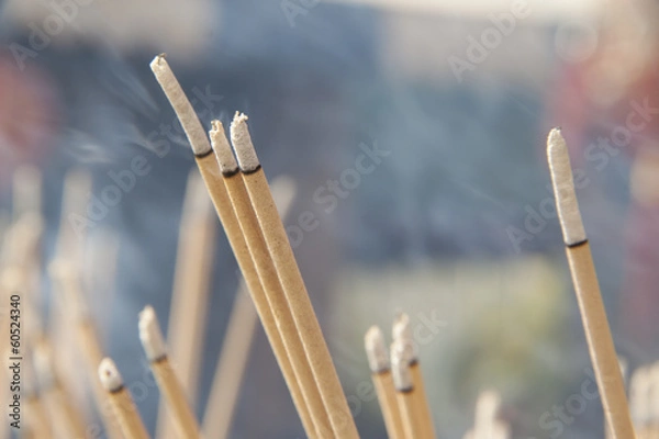Fototapeta Lighted joss sticks in the temple, close-up