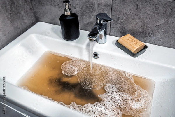 Obraz Clogged sink in bathroom, sink with dirty water, brown soap