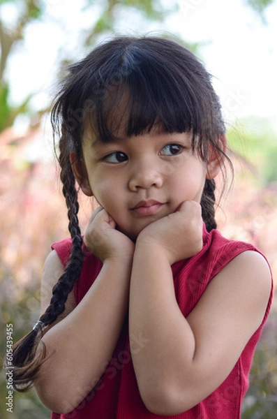 Obraz Portrait of cute little toddler girl child standing over meadow background. Close-up portrait of nice-looking lovely.