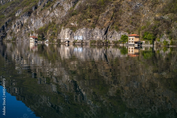 Fototapeta Lake Lugano surrounded by mountains and a small marina with moored boats on a sunny day