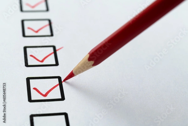 Fototapeta Red pen marking on checklist sheet