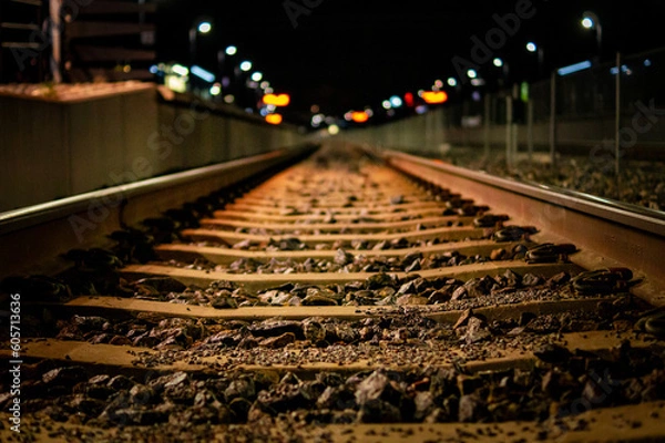 Fototapeta Railway train tracks with soft background at nighttime.