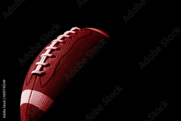 Fototapeta Red American football ball close up on black background. Horizontal sport theme poster, greeting cards, headers, website and app