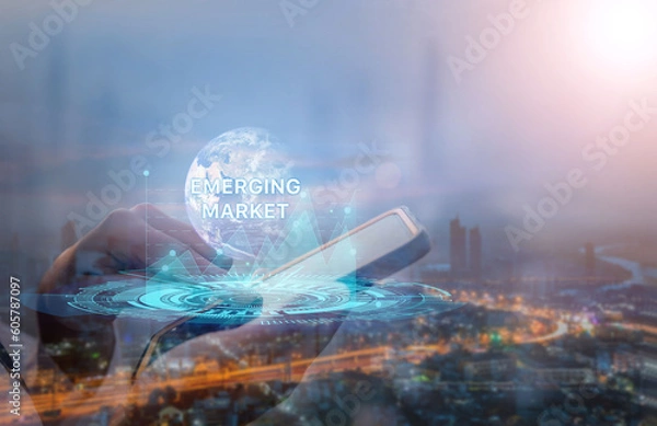 Fototapeta Emerging markets. Internet and network technology business concepts. businessman on smart phone Work on the futuristic virtual screen and see the inscription.