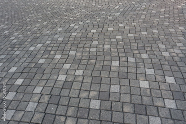 Fototapeta Pavement walkway made with grey, black and white colors stone, with wavy pattern background texture
