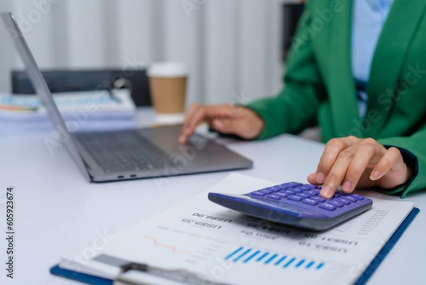 Fototapeta Young busy asian business woman manager, lawyer doing bookkeeping audit graph documents checking Bank Reconciliation, Base Stock, Last Invoice Price, Freight, Drop Product or Drop Section Decisions