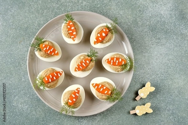 Fototapeta Stuffed eggs with liver pate in the form of carrots