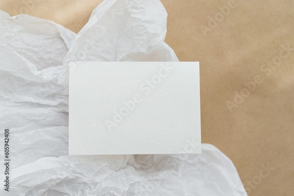 Fototapeta White business card mockup on beige background. Wedding invitation mockup. Name car, place card mock up