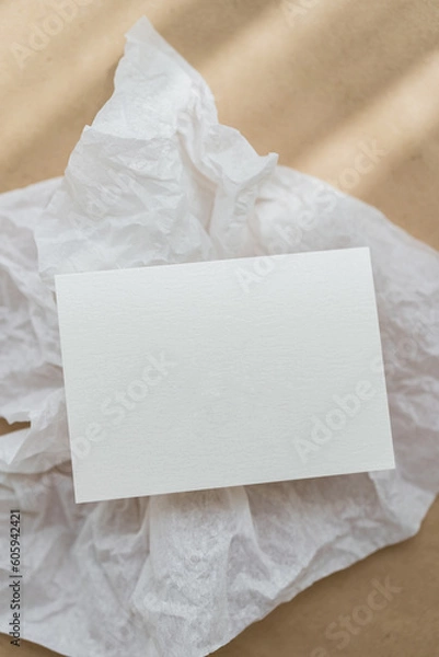 Fototapeta White business card mockup on beige background. Wedding invitation mockup. Name car, place card mock up