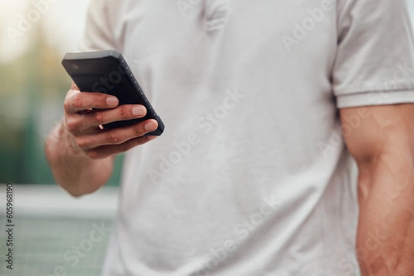 Fototapeta Man, hands and phone for social media, communication or chatting and typing in sports networking on tennis court. Hand of male person or sport athlete on mobile smartphone for online chat or texting